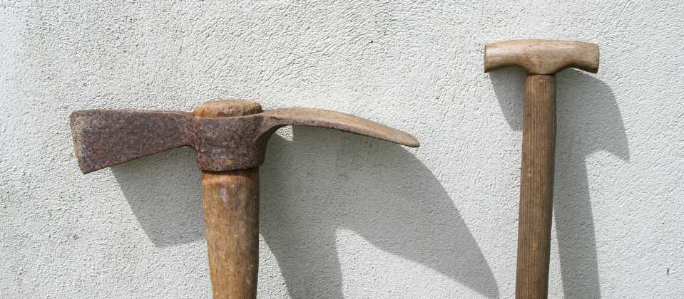 Old mattock and wooden handled garden tool